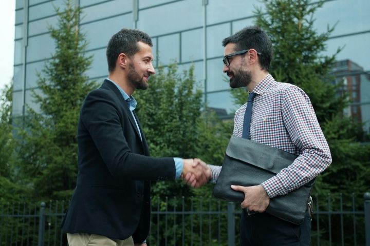 Business buyer and seller shaking hands after completing an acquisition agreement